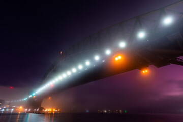 Naklejka na ściany i meble Dawn view of Sydney Harbour Bridge in the fog.