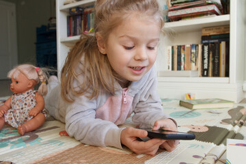 Little cute child holds a smartphone with a green screen. Concept of education online