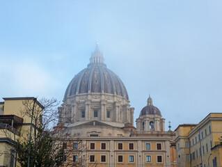 Dome of the church, basilica in the mist. Buildings, tenements, windows, shutters, blue sky.