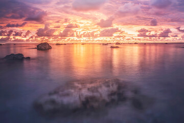 evening sea , beautiful sunset evening coast sea background nature landscape , thailand andaman sea, stones in the water. High quality photo.