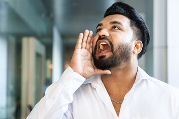 Indian young man shouting or screaming out loud