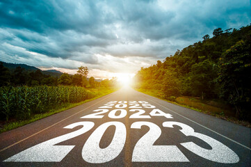 New year 2023 or straight forward concept. Text year 2023, 2024, 2025 written on the road in the...