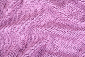 fabric is knitted from woolen yarn. Knitted background. Needlework, handicrafts, hobbies. Close-up