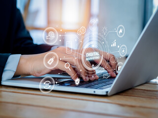 Digital marketing and social media concept. Words with strategy icons appear while people using laptop. Business data solution, seo, content, advertise, branding, communication target to success.