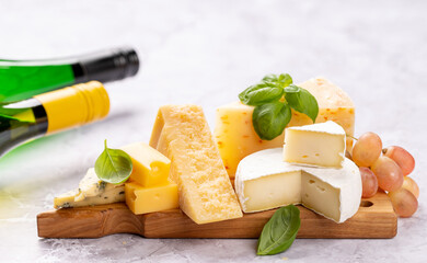 Various cheese on board and white wine