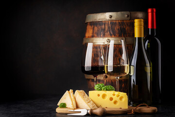 Various cheese on board, red and white wine