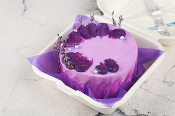 Bento Cake. Small cake in lilac colors in an eco-box. Portion trendy dessert per person