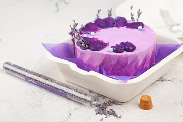 Bento Cake. Small cake in lilac colors in an eco-box. Portion trendy dessert per person