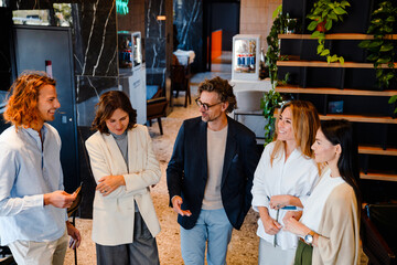 Different age colleagues discussing their project during offline meeting