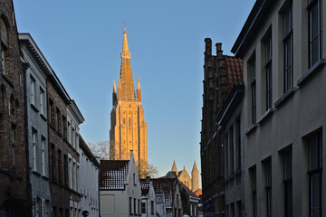 Tower of the church of our Lady in the winter evening sun in Bruges