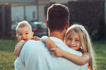 Fototapeta premium Father with happy and smiling children at summer