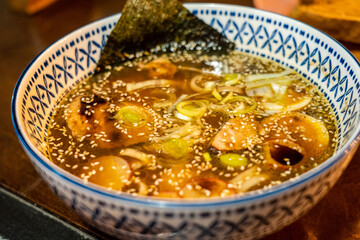 Japanese miso soup with vegetables in bowl on the table