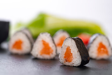 sushi roll with salmon and avocado on a white background