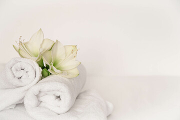 Fototapeta na wymiar Spa composition with lily flowers and towels on a white background.