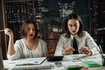 Fototapeta premium Two business woman working together with financial statistics documents