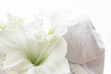 Close-up, lily flowers and a towel on a white background isolated.
