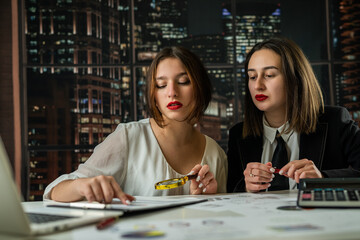 Fototapeta premium Two business woman working together with financial statistics documents