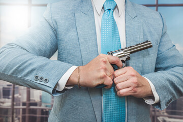 closeup agent in blue suit holding semi-automatic pistol gun