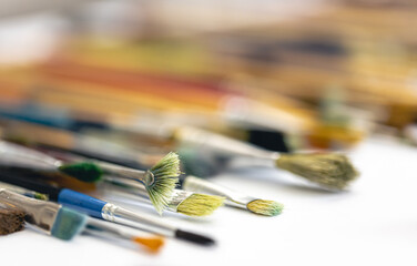 Fototapeta premium Paint brushes stained with paint, close-up, macro shot.