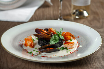 seafood, mussels, salmon on a white plate