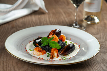 seafood, mussels, salmon on a white plate