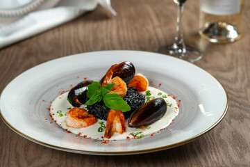 seafood, mussels, salmon on a white plate