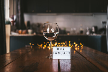 Challenge dry January. Wine glass with water. Non-alcoholic month. - obrazy, fototapety, plakaty