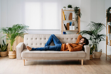 Young man relaxing on sofa at home