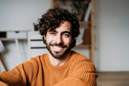 Happy Young Man Sitting At Home