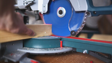 cutting wood with a miter saw. construction tool at work