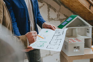 Businessman showing blueprint to colleague at construction site