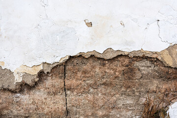 Old damaged mudbrick wall of an old ruined house as background