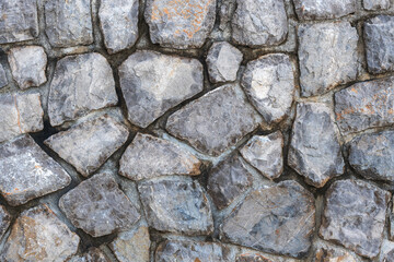 Old stone wall in croatian town of Lovran as background