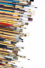 Fototapeta premium Many brushes for painting on a white background, top view.