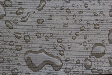 wet wooden planks of bench, background of wood texture with water drops from the rain, autumn mood