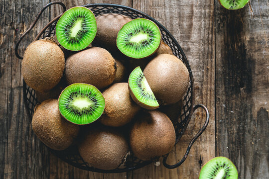 Kiwi fruits on a wooden background, a view of the top.