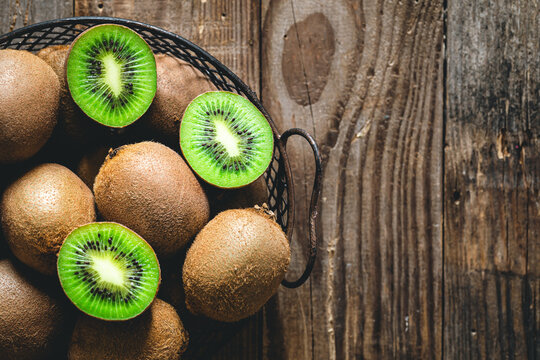 Kiwi fruits on a wooden background, a view of the top.