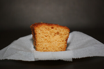 Slice of cake on top of a napkin on the couch