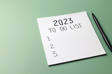 2023 to do list, notebook and pen on green background