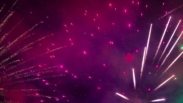 Panoramic view of the colorful fireworks. Beautiful fireworks close-up view in slow motion. Wonderful real fireworks in the night sky shot with a telephoto lens. fireworks show. 4K slow motion video.
