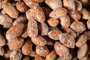 Salted peanuts on dark background. Pile of peanuts. Studio shoot. Top view
