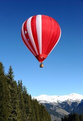 Hot air balloon in winter resort over the slopes in Courchevel French alps