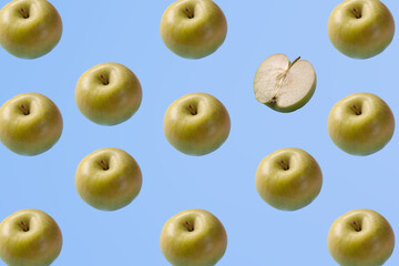 Creative pattern with apples on bright light blue background