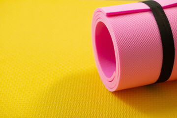 fitness mat on wooden floor, concept of health and sport