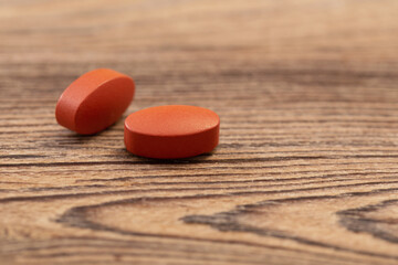 Fototapeta na wymiar two pills on old wooden background