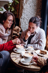 Two girl friends enjoy time together in a coffee meeting