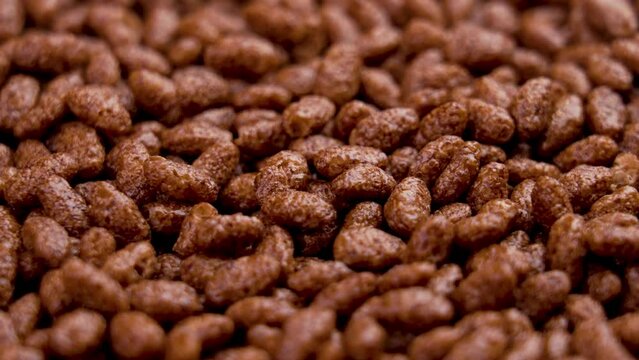 Chocolate cereal puffed rice flakes. Crispy popped choco breakfast. Macro. Rotation