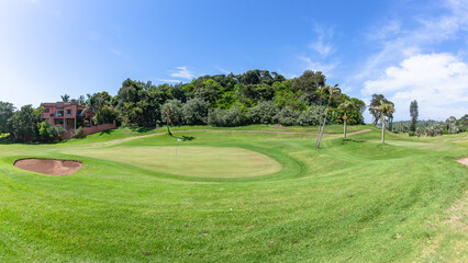 Fototapeta na wymiar Golf Course Two Holes Putting Greens Summer Coastal Lifestyle Landscape.