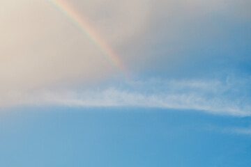 clear sky rainbow background fluffy white clouds