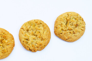 Pistachio and almond cookies on white background.